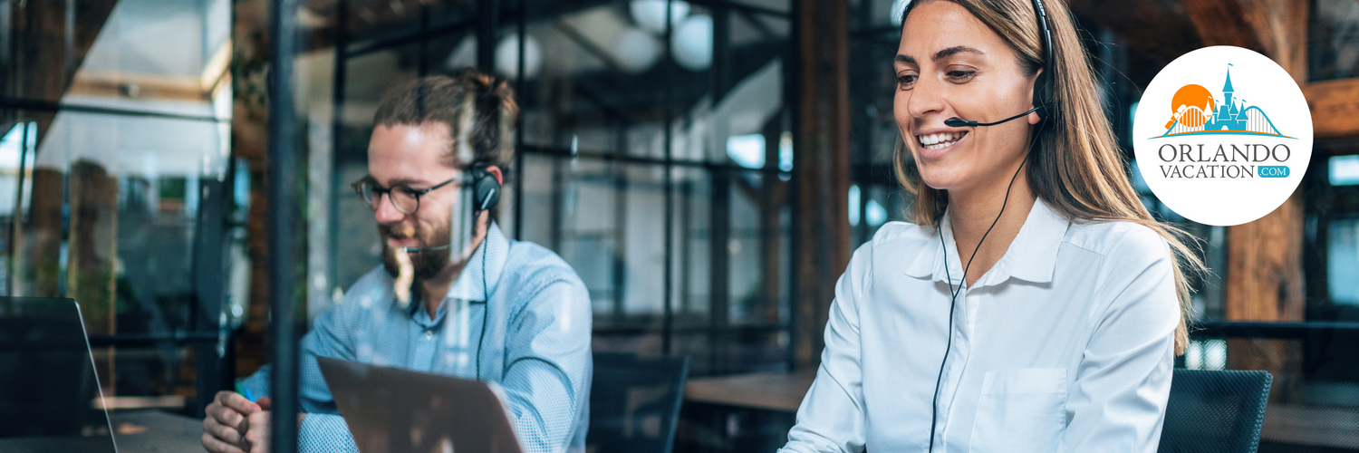 Two customer support agents with headset on taking calls at a computer, helping guests with their trips